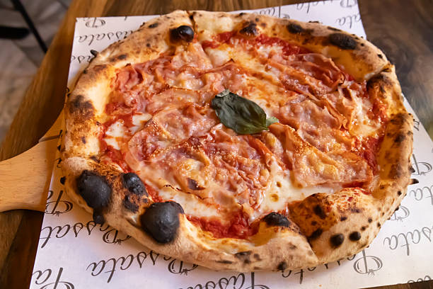 istock italian neapolitan pizza with ham and basil 2204108338