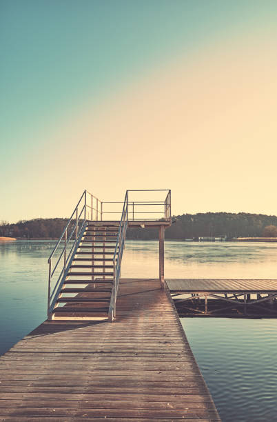 A pier on Barlinek Lake, color toning applied, Poland.