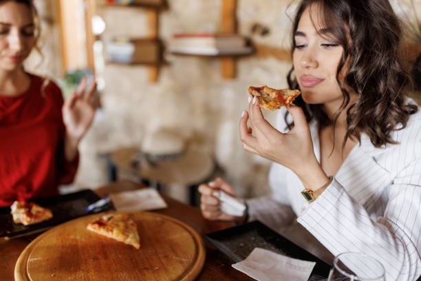 istock Enjoying the taste of pizza 2204119948