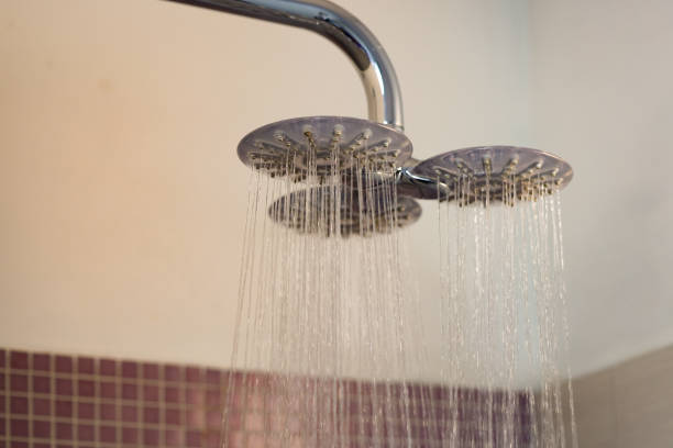 istock Dual Shower Head with Flowing Water in a Modern Bathroom 2204120360