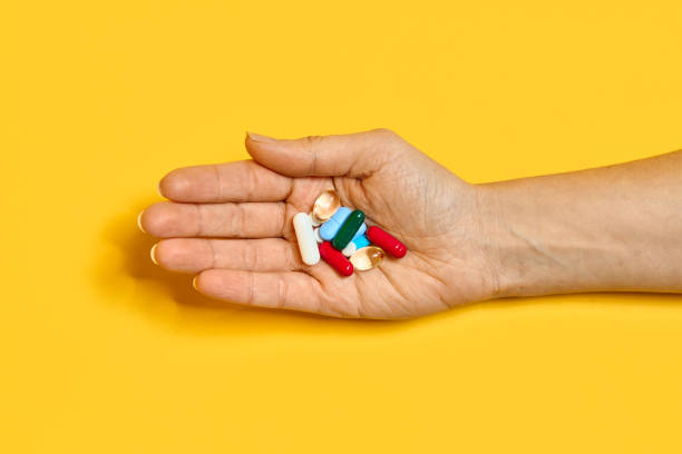 istock Various pills of different colors and shapes at hand 2204120392