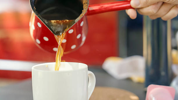 istock Pouring Fresh Coffee into a Mug Outdoors 2204120669