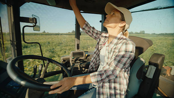 istock Dedicated Female Farmer Operating Tractor in Farmland 2204121801