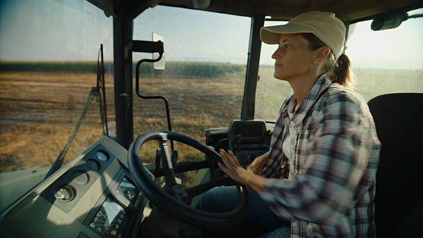 istock Farmer Driving Tractor in Field 2204121855