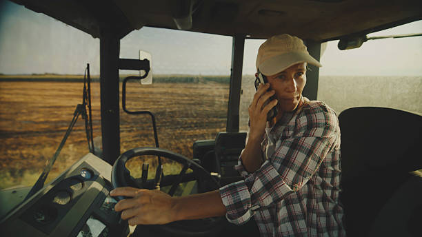 istock Farmer on Phone in Tractor 2204121869