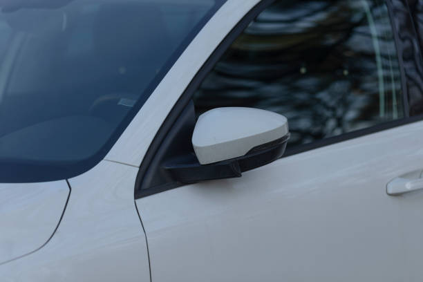 istock A white car with a black mirror is parked by the road 2204123832