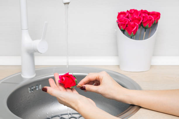 istock woman washing her hands with flower shaped soap 2204128531