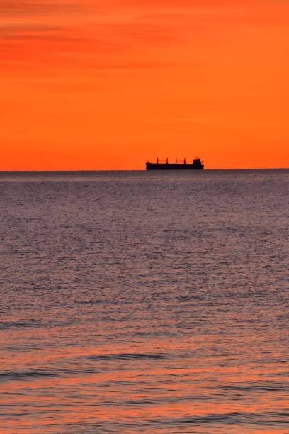 istock Bulk carrier ship on horizon at dawn, Chesapeake Bay 2204128982