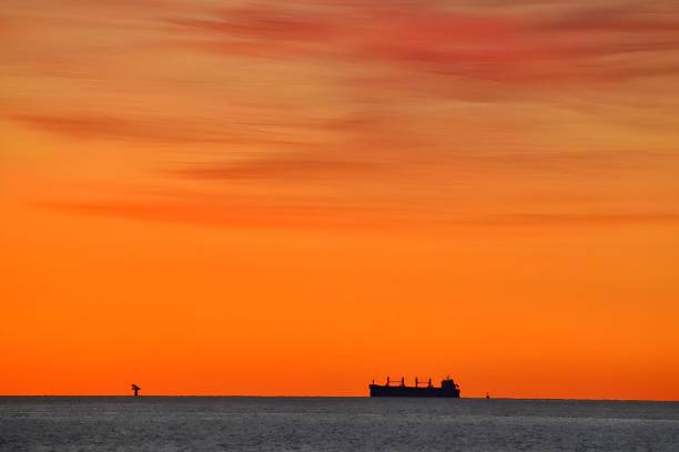 istock Winter dawn and a carrier ship on horizon, Chesapeake Bay 2204128988