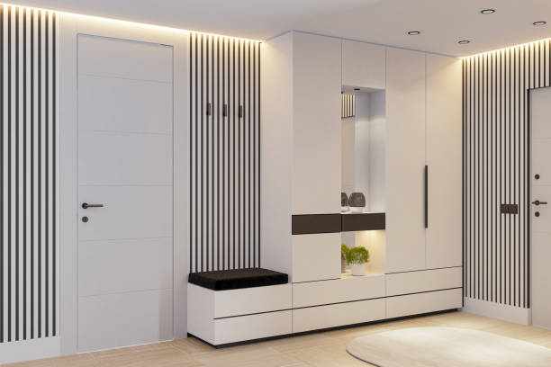 A stylish and contemporary entrance area featuring white doors, wood paneling with sleek stripes, and hidden LED strip lighting from the ceiling. Spotlights enhance the modern gloss-finish MDF closet, complete with hangers, shelves, and drawers. The space is enriched with a combination of hardwood flooring and a natural stone tile accent wall, creating a sophisticated and inviting ambiance. Perfect for renovation concepts, real estate presentations, architectural design firms, and modern interior decoration themes.