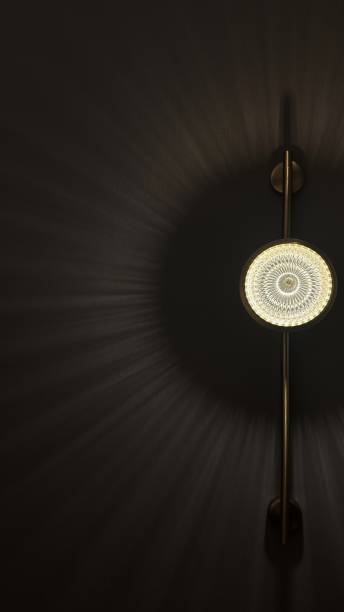Beautiful wall light lamp or sconce on wall, leaving patterns from beams of lights and shadows around. Cozy dark room, interior design, lighting design, hotels and bedrooms, additional light fixtures