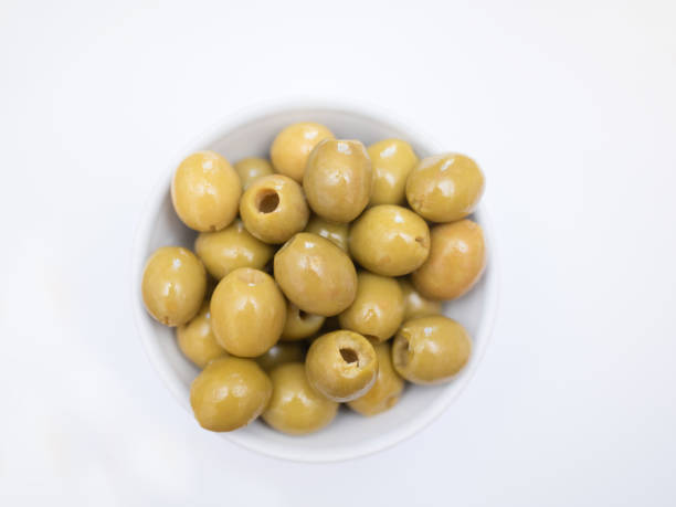 istock pitted green olives in bowl on white background 2204131516