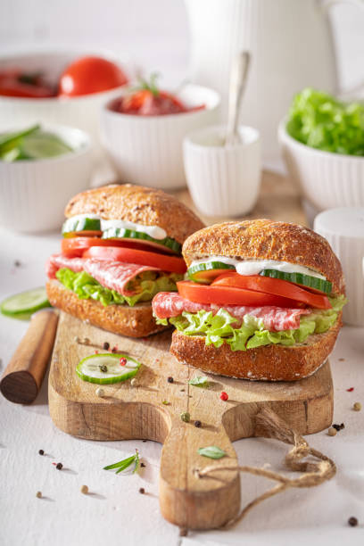 istock Bbold sandwich made with salami, cucumber, and tomato. 2204132376