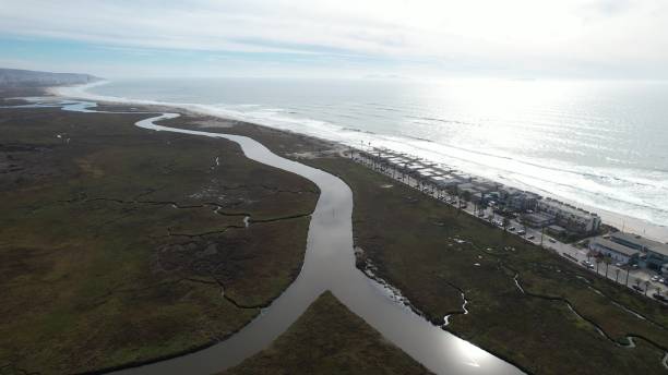 istock Coastal landscape with winding river and ocean. 2204133817