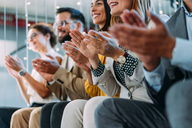 istock Businesspeople applauding during a seminar in conference hall. 2204135370