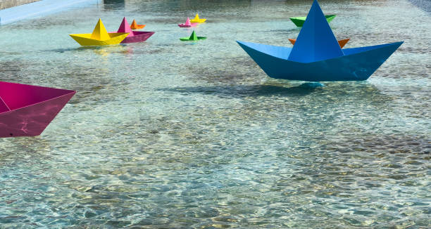 Beautiful paper boat on water outdoors, space for text. High quality photo