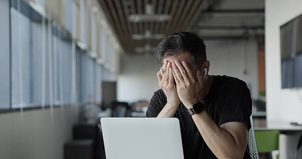 istock Asian businessman burn out on failed job in office. Elderly office worker expresses emotions Failed to work No success. Financial Communication Business problem. Working too hard overtime 2204137921
