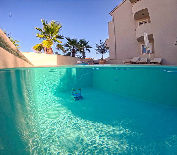 istock Outdoor Villa Pool with Robotic Cleaner Under Clear Blue Sky 2204137925