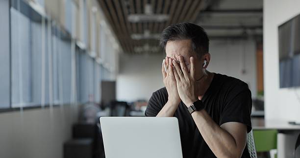 Asian businessman burn out on failed job in office. Elderly office worker expresses emotions Failed to work No success. Financial Communication Business problem. Working too hard overtime