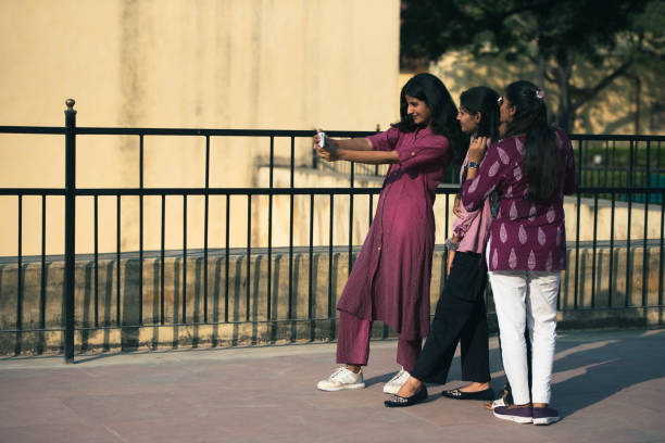 India, Jaipur, November 4, 2024.Three Modern Indian Young Girls Posing on the Street and Taking a Selfie. They Wear Traditional Clothing