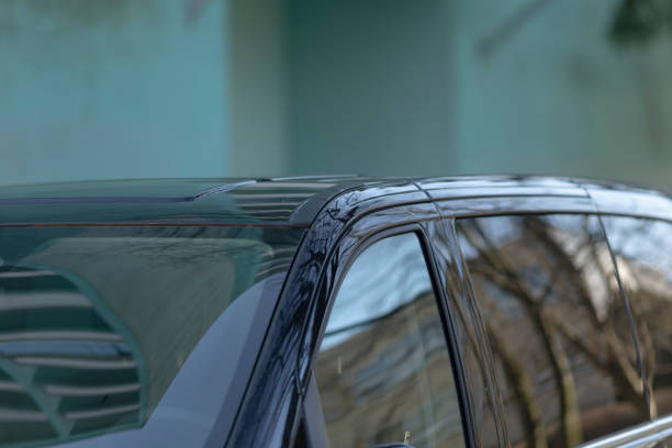 istock A sleek black car is currently parked right in front of a large building 2204146822