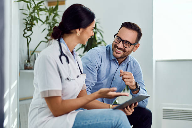 Doctor and Patient in a Smiling Discussion in a Bright Medical Office stock photo
