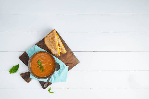Roasted tomato basil soup bisque with a toasted grilled cheese sandwich on whole wheat bread.