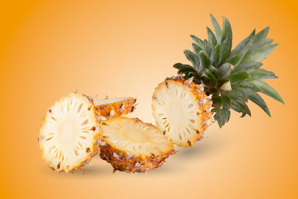 istock Pineapple slices isolated on an orange background 2204149272