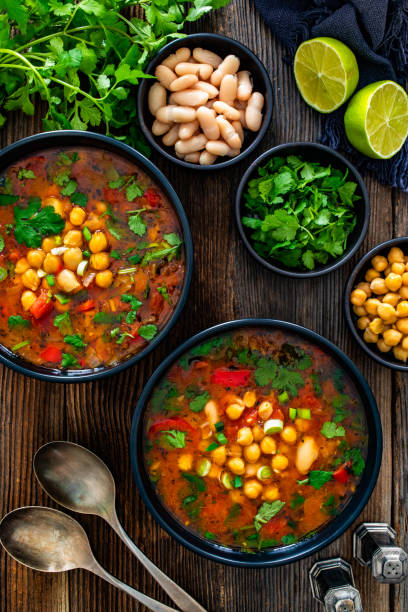 istock Fresh vegetable soup with chick-pea served in white bowl on wooden table 2204149918