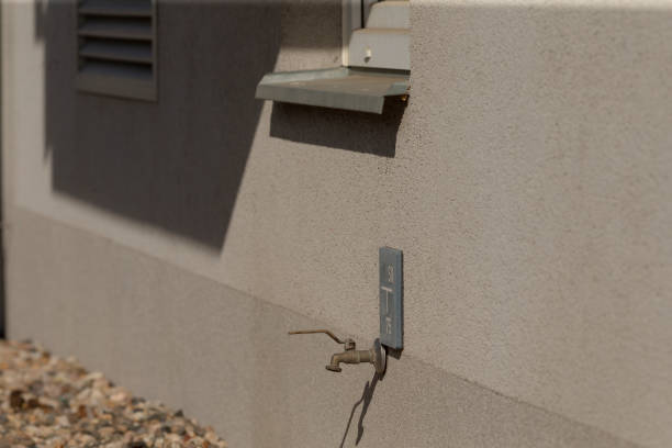 A faucet is securely attached to the side of the building structure, providing a convenient water access point for various needs