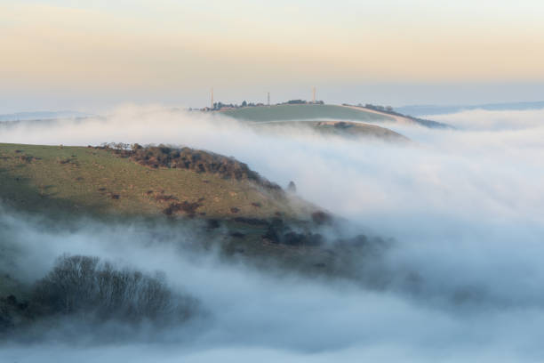 istock Stunning landscape sunrise image of atmospheric cloud inversion over South Downs escarpment 2204155875