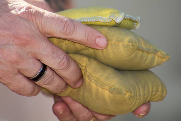 istock Close-up of hands holding cornhole bags 2204156387