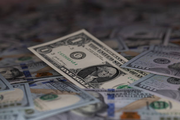 US 1 dollar banknote isolated on US 100 dollar banknotes background for design purpose