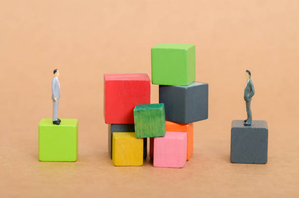 istock Barrier of Blocks Representing Differences in Status and Perspectives 2204164295