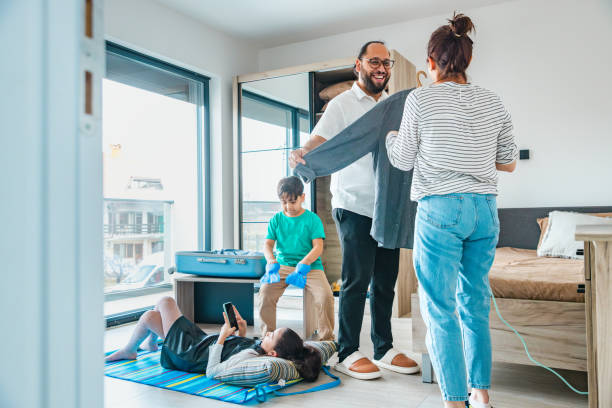 istock Family of four packing a suitcase 2204164559