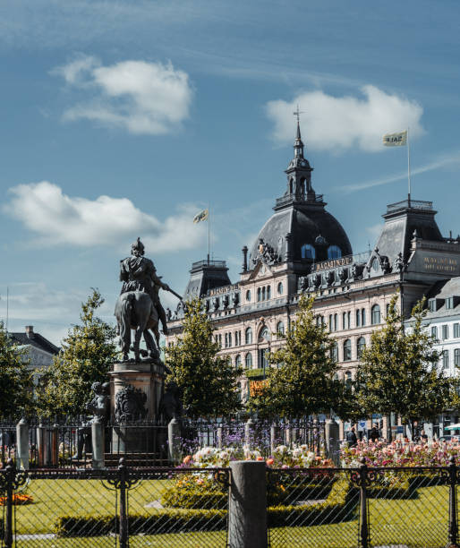 Landmark cobble-stoned square containing a public park and royal equestrian statue of Christian V in Copenhagen, Denmark.