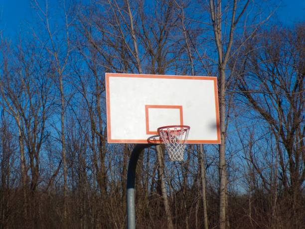 Man on street basketball court practice throwing ball in basket