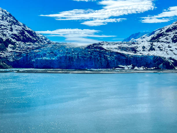 Towering ice formations and pristine blue waters showcase the raw beauty of Alaska's glaciers.