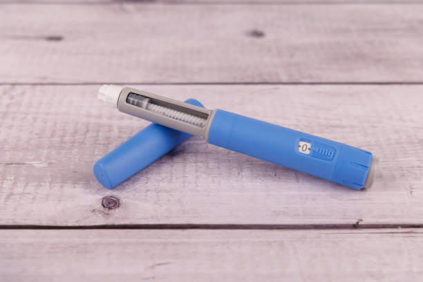 istock The image features a semaglutide pen on a white-painted wooden table, with its box in the background, emphasizing health and treatment 2204174428