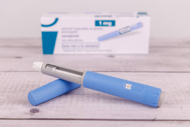 istock A vertical Ozempic pen is shown alongside several other pens and a measuring tape, arranged on a white-painted wooden table, symbolizing health and precision semaglutide pen and its box on a white-painted wooden table, emphasizing health tools and medical 2204174854