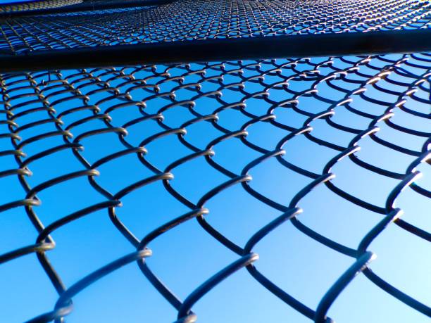 istock Chainlink fence on sunny day with blue sky. 2204176832