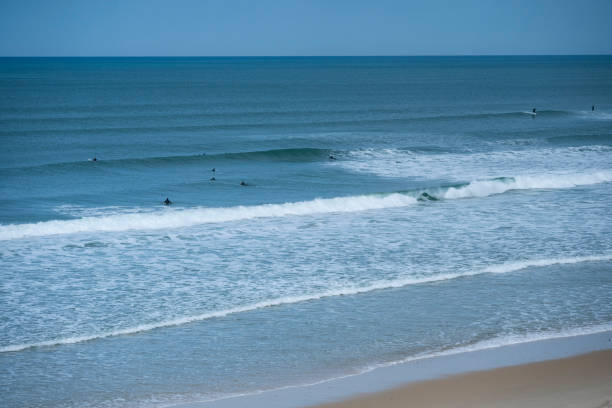 istock Surfing at Biscarrosse Beach as Waves Roll Gently Under a Clear Sky 2204180124