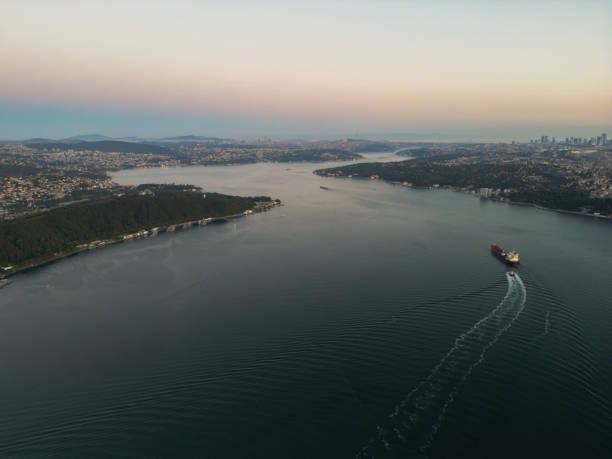 Aerial view of Cargo ship passing under Yavuz Sultan Selim Bridge.