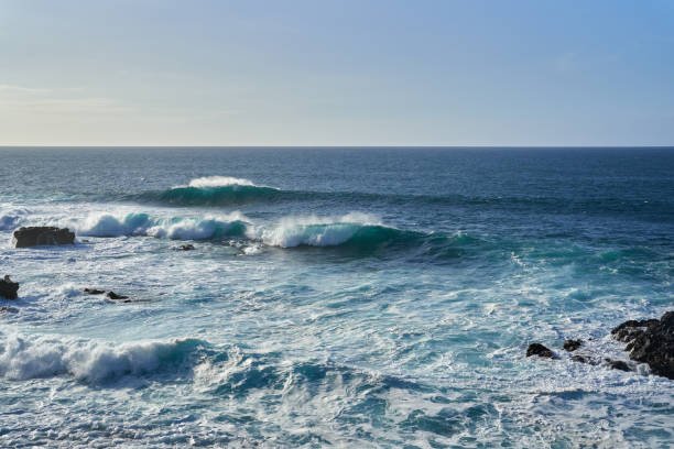 istock Waves crashing on a rocky coastline 2204182111