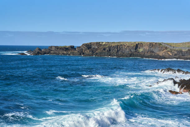 istock Rocky coastline with crashing waves 2204182112
