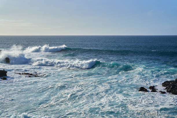 istock Waves crashing on a rocky coastline 2204182221