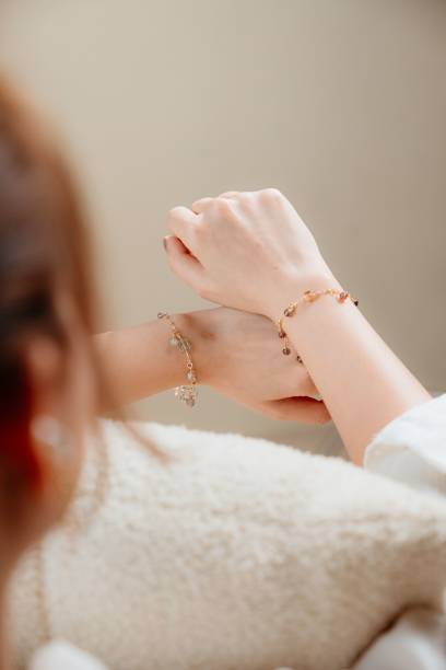 Hands wearing charm bracelets