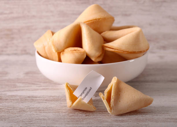istock Fortune cookies, over wooden table 2204183975