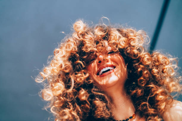 istock Woman with curly hair taking selfie 2204184200