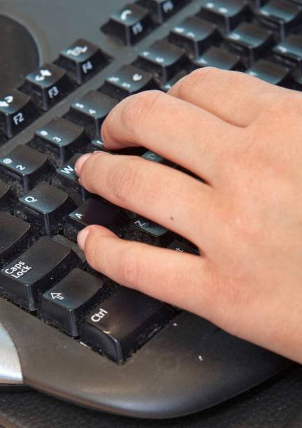 istock Working at the office. Hand on keyboard of a computer 2204185279